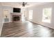 Bright living room featuring a brick fireplace, built-in shelves, and large windows overlooking the beautiful outdoor scenery at 1851 Harvest Way, Loganville, GA 30052