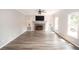 Spacious living room boasts a brick fireplace, built-in shelves, and ample natural light for comfortable living at 1851 Harvest Way, Loganville, GA 30052