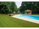 The backyard features an in-ground pool, pool-side furniture, and cabana at 1851 Harvest Way, Loganville, GA 30052