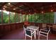 Cozy screened-in porch with outdoor seating and wooded views at 1851 Harvest Way, Loganville, GA 30052