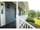 Inviting front porch featuring a white railing and a cozy, shaded area, perfect for relaxation at 1851 Harvest Way, Loganville, GA 30052