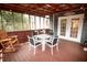 The screened porch is furnished with outdoor dining and lounge furniture at 1851 Harvest Way, Loganville, GA 30052