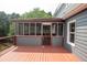 The exterior side view features a screened porch and gray wood paneling at 1851 Harvest Way, Loganville, GA 30052