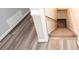 Stairway with carpeted steps leading to basement, featuring modern gray laminate flooring landing at 1851 Harvest Way, Loganville, GA 30052