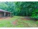 Lush backyard offers ample green space and a covered patio at 604 Hamlet Se Ct, Conyers, GA 30094