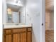 Well-lit bathroom featuring a neutral countertop and warm wood cabinetry at 604 Hamlet Se Ct, Conyers, GA 30094