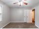 Cozy bedroom features neutral paint, carpet, and ceiling fan at 604 Hamlet Se Ct, Conyers, GA 30094