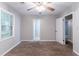 Bedroom features neutral paint, carpet, ceiling fan and window at 604 Hamlet Se Ct, Conyers, GA 30094