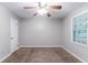 Bedroom features neutral paint, carpet, ceiling fan and window at 604 Hamlet Se Ct, Conyers, GA 30094