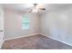 Bedroom features neutral paint, carpet, ceiling fan and a window at 604 Hamlet Se Ct, Conyers, GA 30094