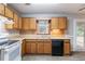 Well-lit kitchen with wood cabinets, modern appliances, and a view to the backyard at 604 Hamlet Se Ct, Conyers, GA 30094