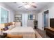 Comfortable bedroom featuring a ceiling fan, natural light, and neutral tones at 604 Hamlet Se Ct, Conyers, GA 30094
