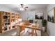 Bright office space with a large desk, bookshelves, ceiling fan and natural lighting at 604 Hamlet Se Ct, Conyers, GA 30094