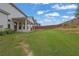 Wide-open backyard showcases green grass and a sturdy wooden fence, offering privacy and space at 6135 Stillwood Ln, Cumming, GA 30041