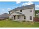 Expansive backyard featuring a covered porch, lush green grass, and privacy fence at 6135 Stillwood Ln, Cumming, GA 30041