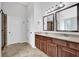 Bright bathroom with a double sink vanity, tile flooring, and glass shower at 6135 Stillwood Ln, Cumming, GA 30041