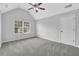 Spacious bedroom with vaulted ceiling, large window for natural light and neutral carpet at 6135 Stillwood Ln, Cumming, GA 30041