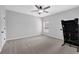 Spacious bedroom with neutral carpet, a ceiling fan, and a bright window at 6135 Stillwood Ln, Cumming, GA 30041