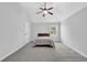 Bright bedroom featuring a comfortable bed, vaulted ceiling, and a view from the window at 6135 Stillwood Ln, Cumming, GA 30041