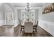 Dining room boasts hardwood floors, coffered ceiling, modern chandelier, and lots of light at 6135 Stillwood Ln, Cumming, GA 30041