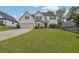 Charming two-story home with a well-manicured lawn and a two-car garage at 6135 Stillwood Ln, Cumming, GA 30041