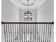 Elegant foyer showcasing a decorative chandelier, high ceiling, and wrought iron banister at 6135 Stillwood Ln, Cumming, GA 30041