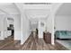 Bright foyer with hardwood floors, decorative molding, and views of the kitchen and living areas at 6135 Stillwood Ln, Cumming, GA 30041