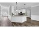 Open kitchen featuring granite countertops and modern white cabinetry at 6135 Stillwood Ln, Cumming, GA 30041
