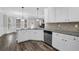 Bright and open kitchen design with stainless steel dishwasher at 6135 Stillwood Ln, Cumming, GA 30041