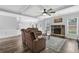 Living room with stone fireplace, coffered ceiling, and open layout at 6135 Stillwood Ln, Cumming, GA 30041