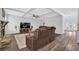 Inviting living room with a stone fireplace, large TV, and stylish decor, perfect for relaxation at 6135 Stillwood Ln, Cumming, GA 30041