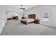 A large main bedroom features an attached office nook, ceiling fan, and neutral walls at 6135 Stillwood Ln, Cumming, GA 30041
