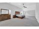 Spacious main bedroom featuring vaulted ceilings, a ceiling fan, and wooden furniture at 6135 Stillwood Ln, Cumming, GA 30041