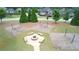 Picturesque community park featuring swings, a fire pit, and well-manicured landscaping at 6135 Stillwood Ln, Cumming, GA 30041
