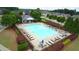 Aerial view of a sparkling community pool with ample lounge chairs and meticulously maintained landscaping at 6135 Stillwood Ln, Cumming, GA 30041
