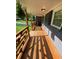 Covered porch featuring a wood design pattern railing with hanging plants and recessed lighting at 2319 Beecher Sw Rd, Atlanta, GA 30311
