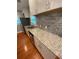 Kitchen features granite countertops, stainless steel appliances, tile backsplash, and wood flooring at 2319 Beecher Sw Rd, Atlanta, GA 30311