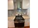 Modern kitchen boasts stainless steel gas range, granite countertops and stylish backsplash at 2319 Beecher Sw Rd, Atlanta, GA 30311