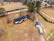 Expansive aerial view showcasing the home's layout, surrounding land, outbuildings, and outdoor amenities at 4739 Lower Jersey Rd, Oxford, GA 30054