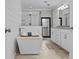 Luxurious bathroom featuring a freestanding tub, glass-enclosed shower, and modern vanity at 4739 Lower Jersey Rd, Oxford, GA 30054