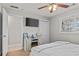 Bright bedroom featuring a TV and faux fireplace, offering a cozy retreat at 4739 Lower Jersey Rd, Oxford, GA 30054