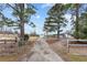 Long driveway leading to a secluded property with mature trees, offering privacy and space at 4739 Lower Jersey Rd, Oxford, GA 30054