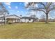 Sprawling ranch-style home featuring white painted brick, a large front lawn, and attached carport at 4739 Lower Jersey Rd, Oxford, GA 30054