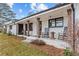 Inviting front porch with rocking chairs and wooden columns, perfect for relaxing and enjoying the outdoors at 4739 Lower Jersey Rd, Oxford, GA 30054