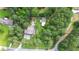 Beautiful aerial view of property showcasing large lot, mature trees, and proximity to neighborhood at 1268 Harris Road Rd, Lawrenceville, GA 30043