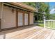 Back door with an awning that opens onto a wooden deck and landscaped yard at 1268 Harris Road Rd, Lawrenceville, GA 30043