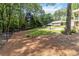 Spacious backyard with lush lawn, patio area, and mature trees provides a private outdoor retreat at 1268 Harris Road Rd, Lawrenceville, GA 30043