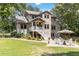 Beautiful backyard showcasing a patio with chairs, steps to a porch and lush lawn at 1268 Harris Road Rd, Lawrenceville, GA 30043