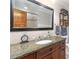 Bathroom features a granite-topped vanity, decorative mirror and a tiled shower/bath at 1268 Harris Road Rd, Lawrenceville, GA 30043