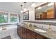 Bathroom features double vanity, granite countertop, and a soaking tub at 1268 Harris Road Rd, Lawrenceville, GA 30043
